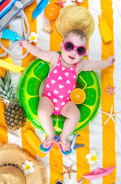 Baby on a beach towel at the sea. Selective focus. Child. - Photo, Image