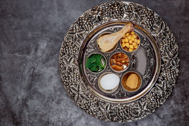 Jewish seder with egg, bone, herbs and walnut Passover holiday concept. - Photo, Image