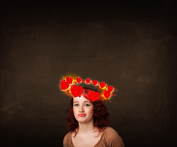teenager girl with heart illustrations circleing around her head - Φωτογραφία, εικόνα