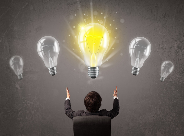 Business person having an idea light bulb concept - Fotó, kép