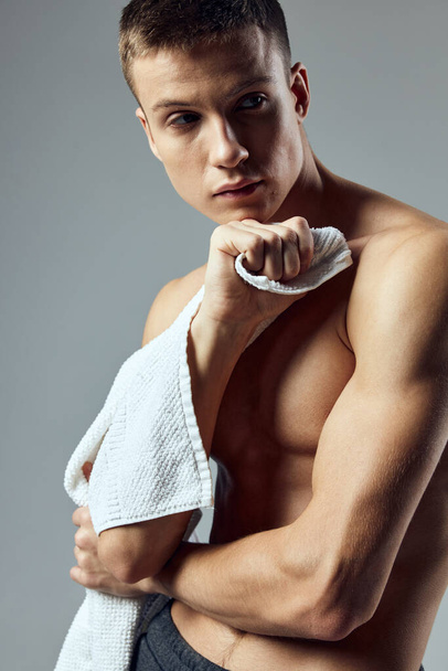 sporty man with towel in hands workout gym close-up - Zdjęcie, obraz