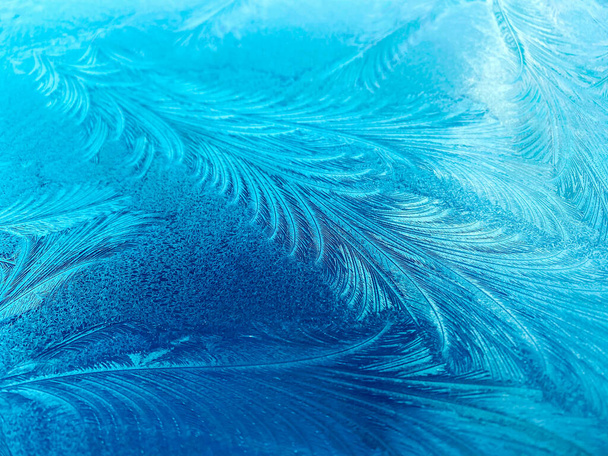 Hairy blue frost pattern - blue ice flowers on the window glass.Cold winter morning - Photo, Image