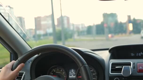 Visão traseira do motorista feminino atrás do volante dirigindo um carro em uma rua da cidade. - Filmagem, Vídeo