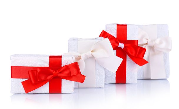 Beautiful gifts with red ribbons, isolated on white - Фото, зображення