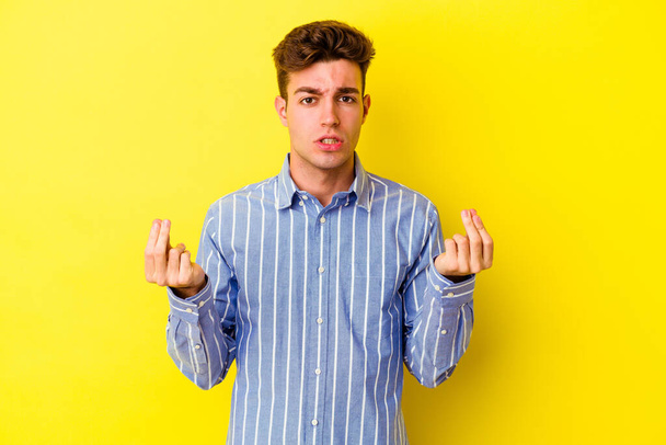 Young caucasian man isolated on yellow background showing that she has no money. - 写真・画像