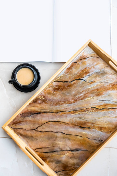 Handmade wood serving tray decorated with marble effect. Epoxy resin art decor. Magazine mock up. Background for DIY master class. Fluid art or acrylic decorative tray. A cup of coffee - Photo, Image