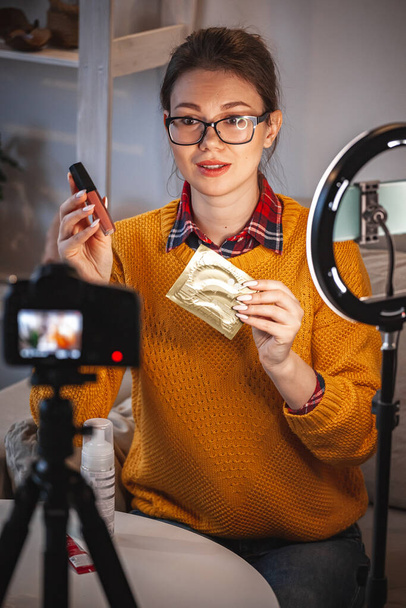 Woman beauty blogger makes a video review of cosmetics at home - Valokuva, kuva