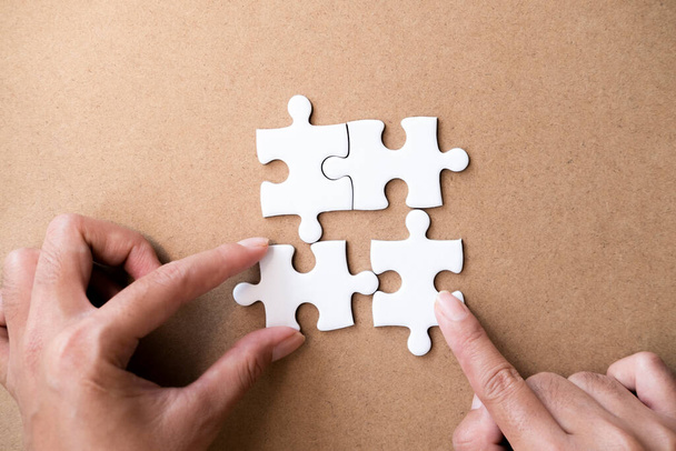 Hands holding jigsaw puzzles. Business partnership and teamwork concept.  - Photo, Image