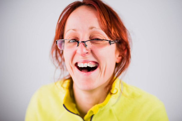 Funny ugly hispanic adult woman smile from a silly joke. Moron and dumb face portrait with mad gesture - Zdjęcie, obraz