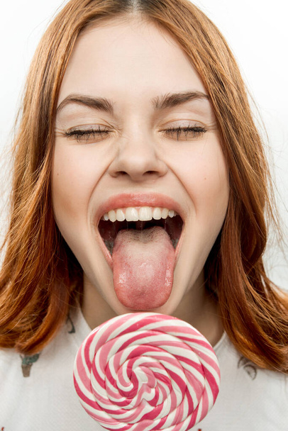 красива жінка лиже круглий льодяник насолода десерт цукерки
 - Фото, зображення