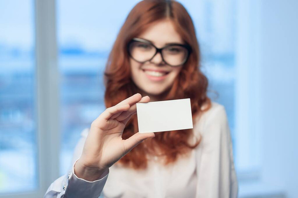 cheerful business woman holding a business card office executive financial coffee space - Фото, зображення