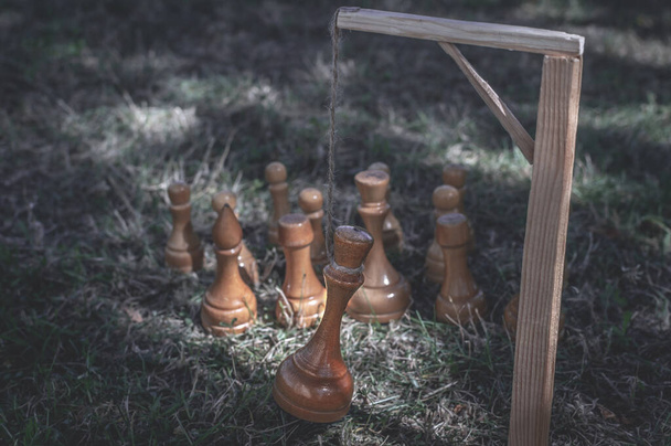 Chess pieces executed their king by hanging from the gallows. The concept of revolution, uprising, assassination of the king, betrayal of national elites, change of power, fall of the dictatorship - Photo, Image