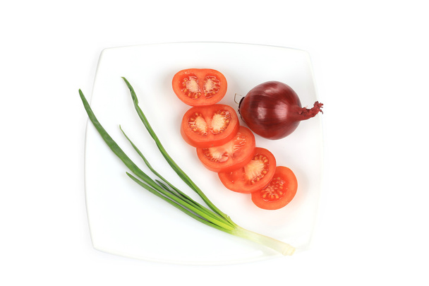 Spring onion and sliced tomato on the plate. - Fotoğraf, Görsel