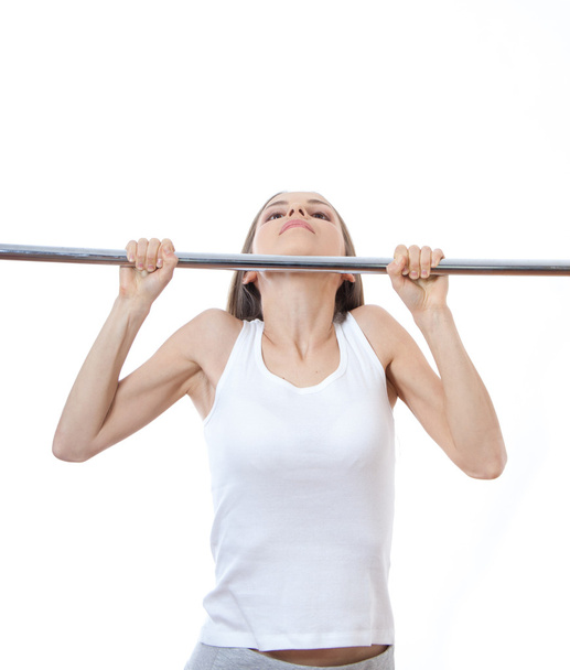 Woman exercising on pull-up bar - Foto, Imagen