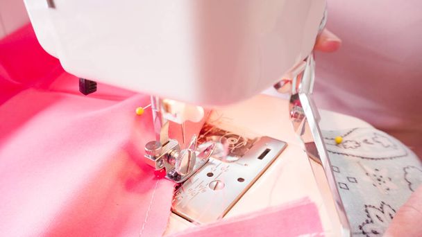 Sewing cotton face mask with a sewing machine for coronavirus outbreak. - Photo, Image