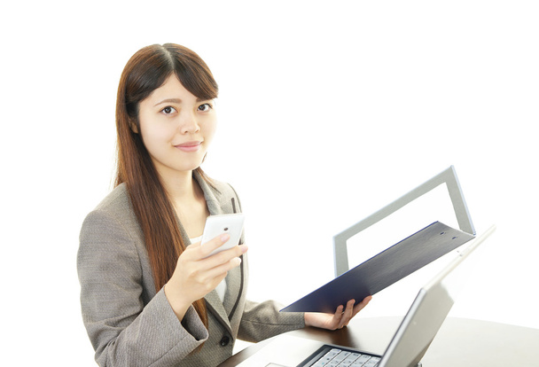 The female office worker who uses the smart phone - Photo, Image