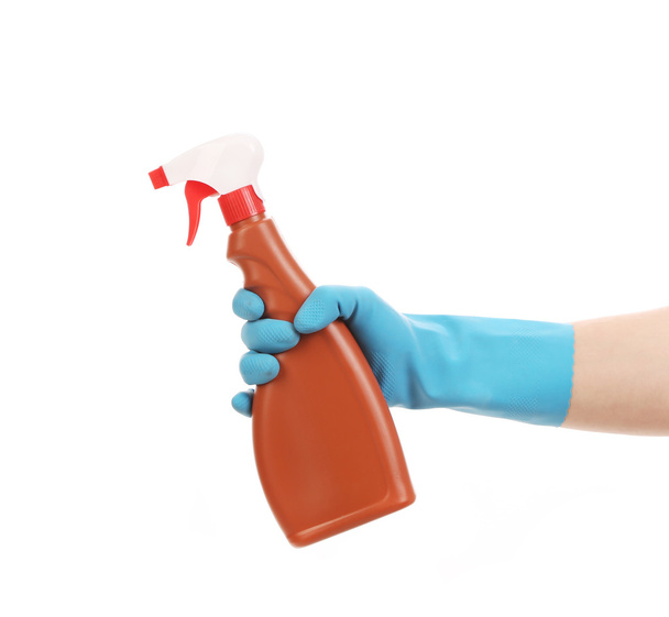 Hand in glove holding brown plastic spray bottle. - 写真・画像