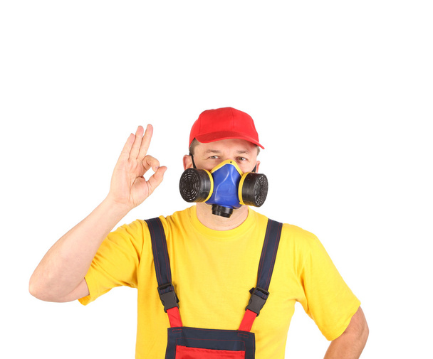 Worker in gas mask showing okay sign. - Фото, изображение