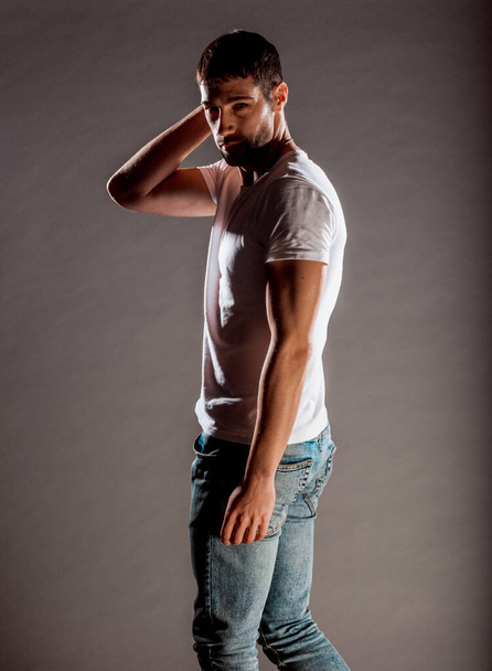 Portrait of a handsome male model posing in cool fashionable clothing - Фото, зображення