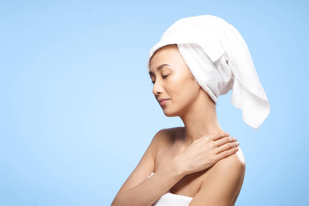 woman of asian appearance bare shoulders towel on head shower rest - Foto, Imagen