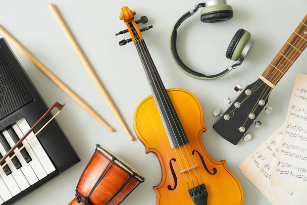 Different musical instruments and music notes on light background - Foto, Imagem