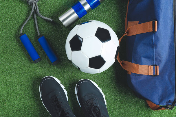 Composition with bag and sports equipment on color background, closeup - Photo, Image