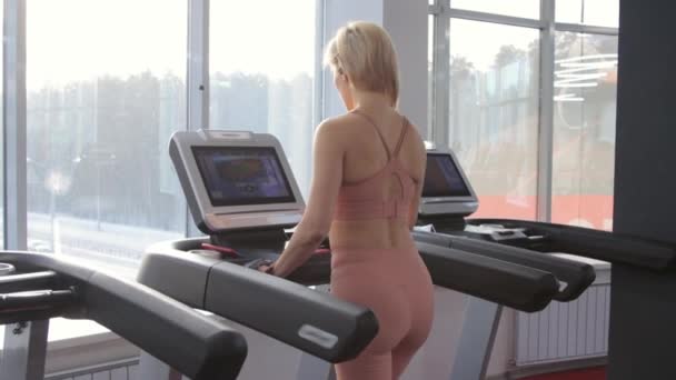 Young woman training on treadmill - Footage, Video