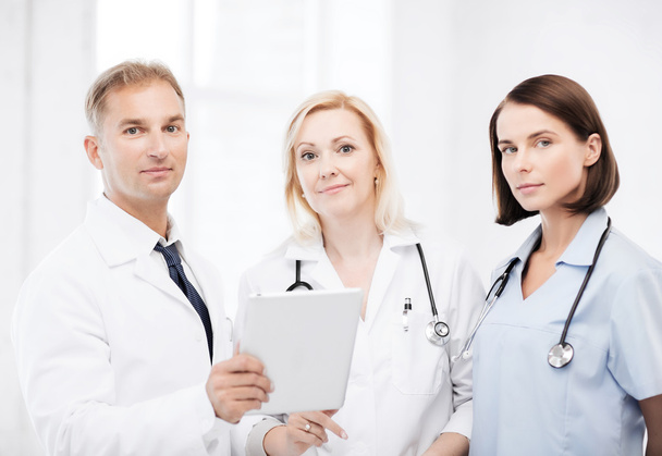 Doctors looking at tablet pc - Фото, изображение