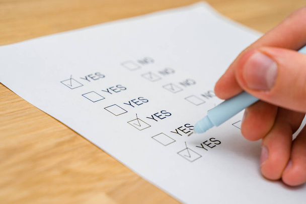  Un formulario de encuesta con opciones de respuesta sí o no. Cuestionario sobre papel blanco, casillas marcadas - Foto, Imagen