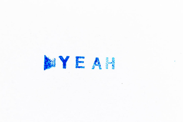 Blue color ink of rubber stamp in word yeah on white paper background - Photo, Image