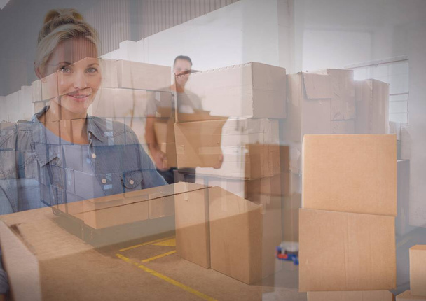 Composition of couple carrying cardboard boxes over stack boxes in warehouse. moving house, global shipment and delivery concept digitally generated image. - Fotoğraf, Görsel