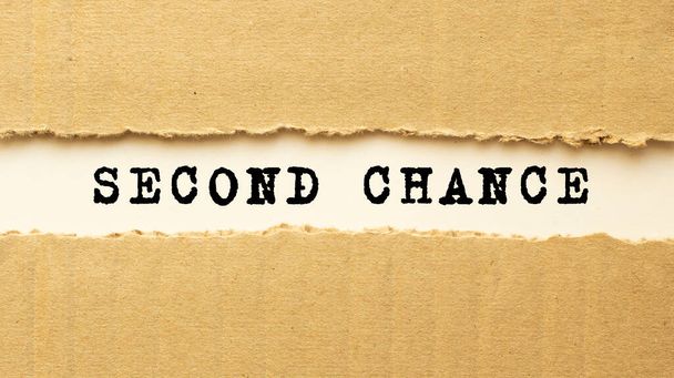 Text SECOND CHANCE appearing behind torn brown paper. - Photo, Image