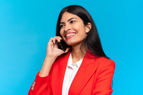 young hispanic businesswoman using her telephone - Foto, afbeelding
