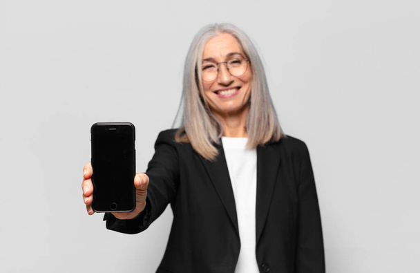 senior pretty businesswoman with a smart phone. - Foto, Imagen