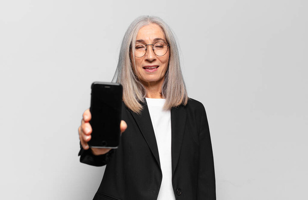 senior pretty businesswoman with a smart phone. - Foto, Imagen