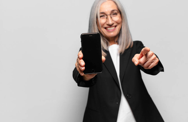 senior pretty businesswoman with a smart phone. - Foto, afbeelding