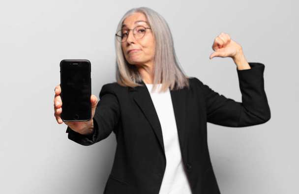 senior pretty businesswoman with a smart phone. - Фото, изображение