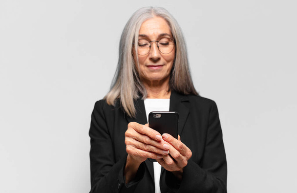 senior pretty businesswoman with a smart phone. - Foto, Imagem