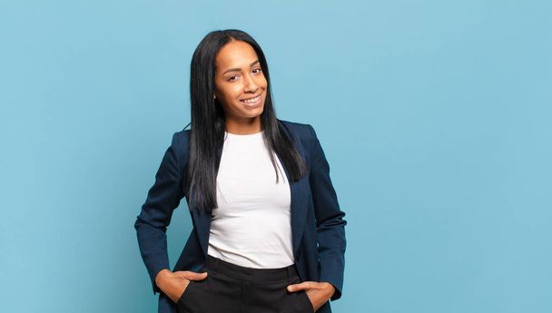 young black woman smiling cheerfully and casually with a positive, happy, confident and relaxed expression. business concept - Foto, Bild