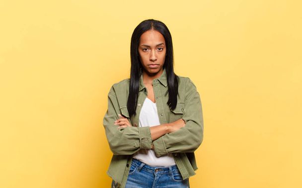 young black woman feeling displeased and disappointed, looking serious, annoyed and angry with crossed arms - Фото, зображення