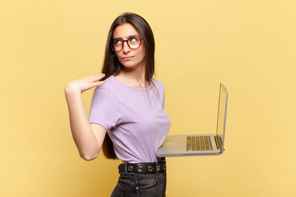 young pretty woman feeling stressed, anxious, tired and frustrated, pulling shirt neck, looking frustrated with problem. laptop concept - Foto, imagen