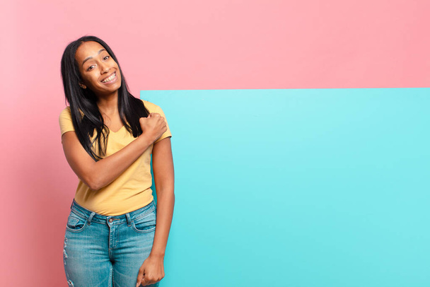 young black woman feeling happy, positive and successful, motivated when facing a challenge or celebrating good results. copy space concept - Foto, imagen