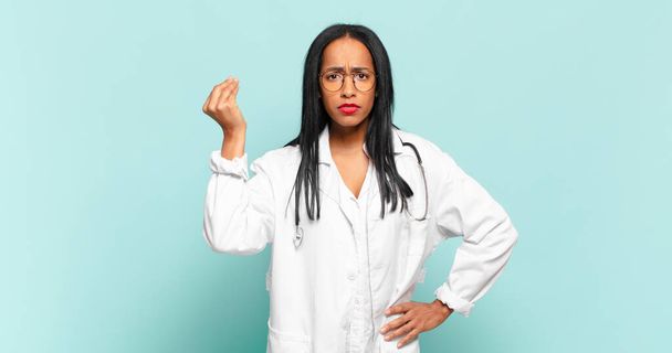young black woman making capice or money gesture, telling you to pay your debts!. physician concept - Foto, Bild