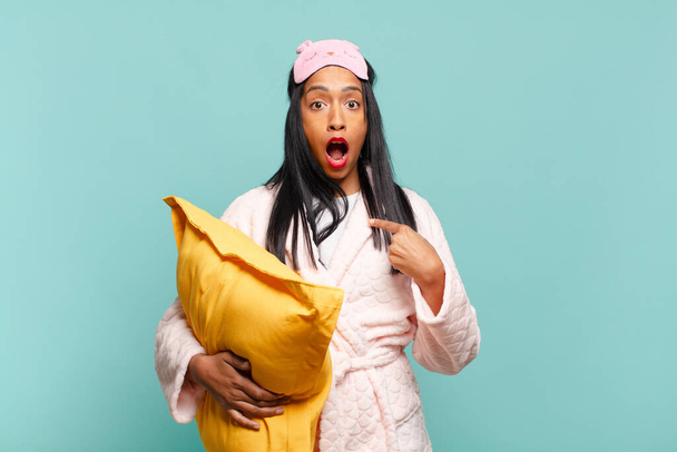 young black woman looking shocked and surprised with mouth wide open, pointing to self. pajamas concept - Fotoğraf, Görsel