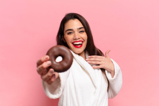 young pretty hispanic woman. happy and surprised expression. breakfast concept - Фото, изображение