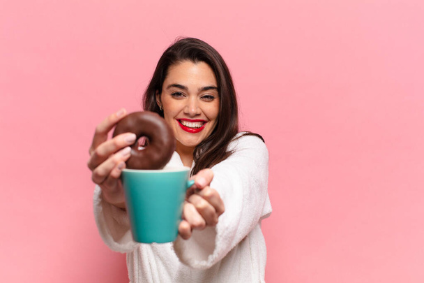 young pretty hispanic woman. happy and surprised expression. breakfast concept - 写真・画像