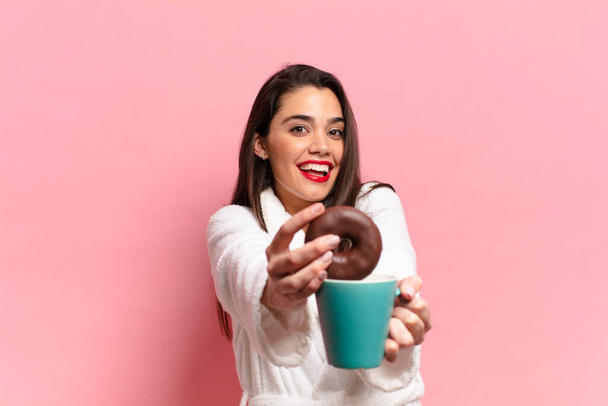 young pretty hispanic woman. happy and surprised expression. breakfast concept - Foto, afbeelding