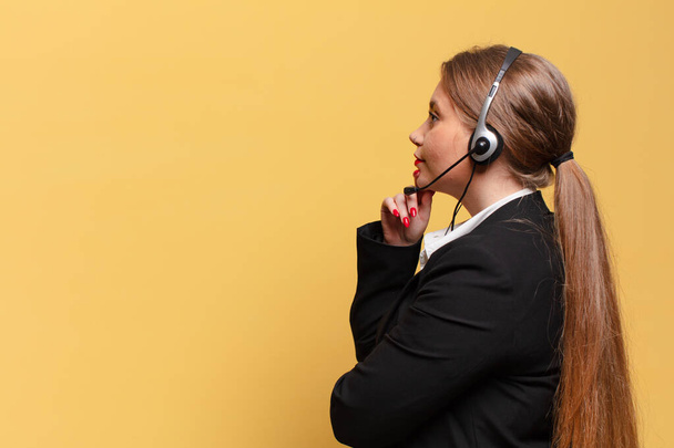young pretty woman thinking or doubting telemarketer concept - Photo, image
