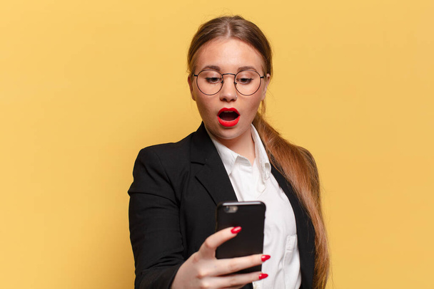 young pretty woman. shocked or surprised expression smart phone concept - Фото, зображення
