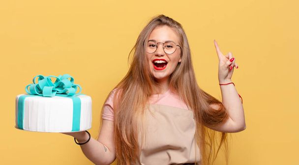 young pretty woman. pointing gesture. proud expression birthday cake concept - Fotoğraf, Görsel